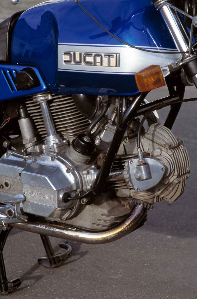 Ducati 860 bevel-drive V-twin engine with finned cylinders, chrome exhaust and tank badge