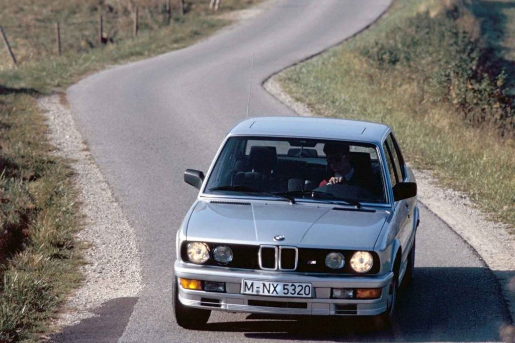 Silver BMW M535i E28 five-series saloon driven head-on along a winding rural road