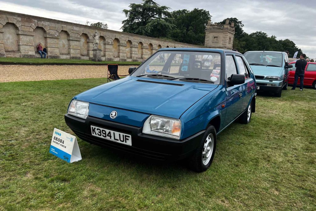 Front three-quarter view of a teal blue 1992 Skoda Favorit five-door hatchback on display at a classic car show