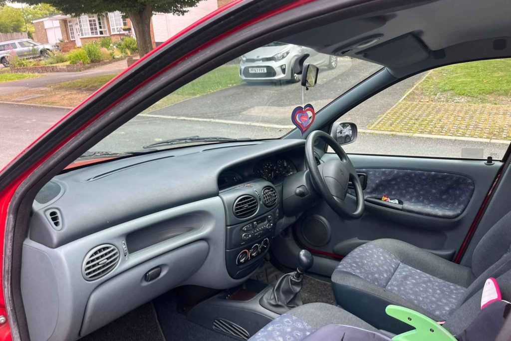 Interior of a car viewed through the open driver's door