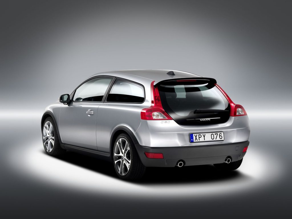 Rear three-quarter view of a silver Volvo C30 with spoiler and dual exhaust